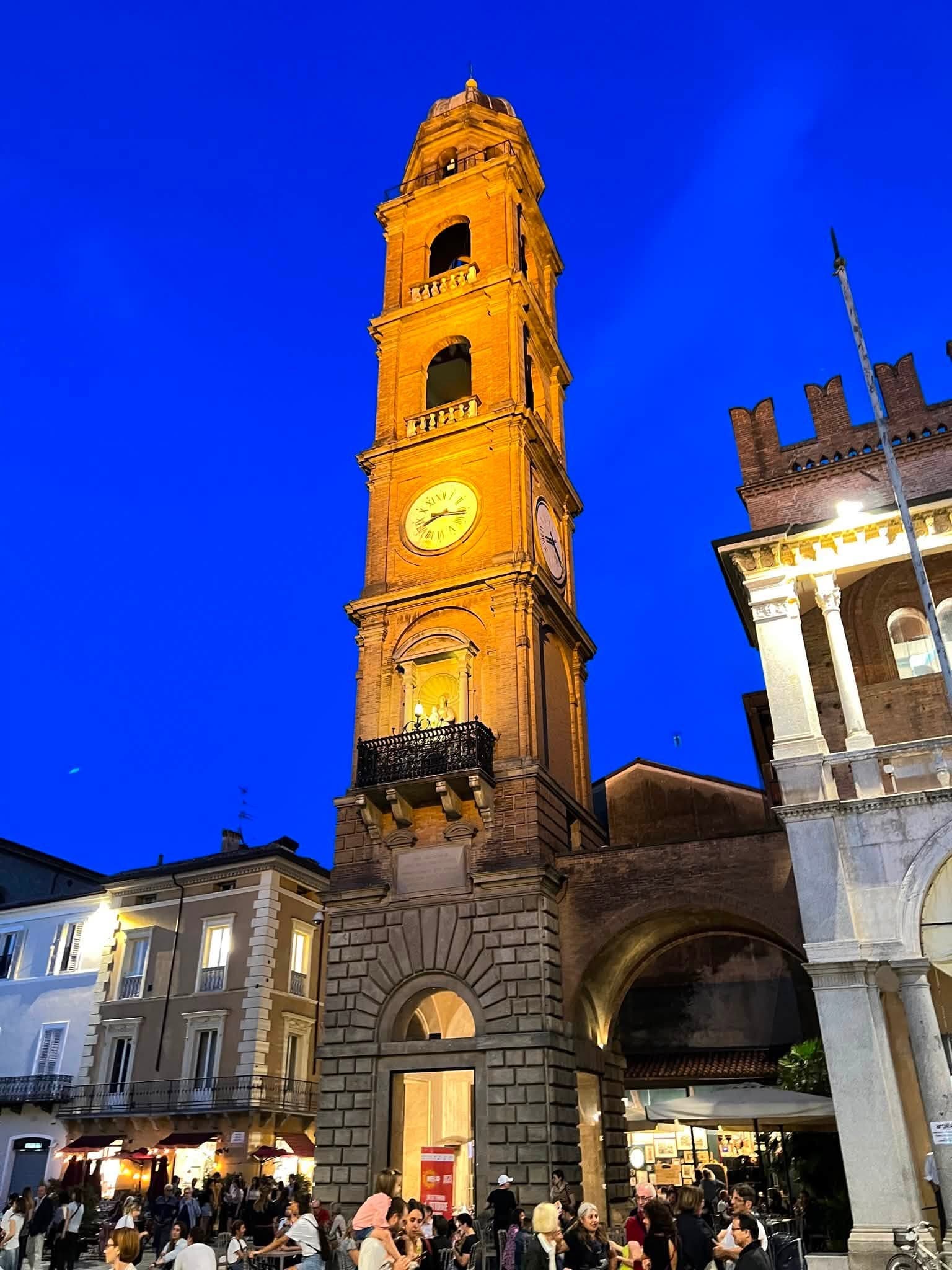 The illuminated clock tower in Faenza during Argillà Italia 2026
