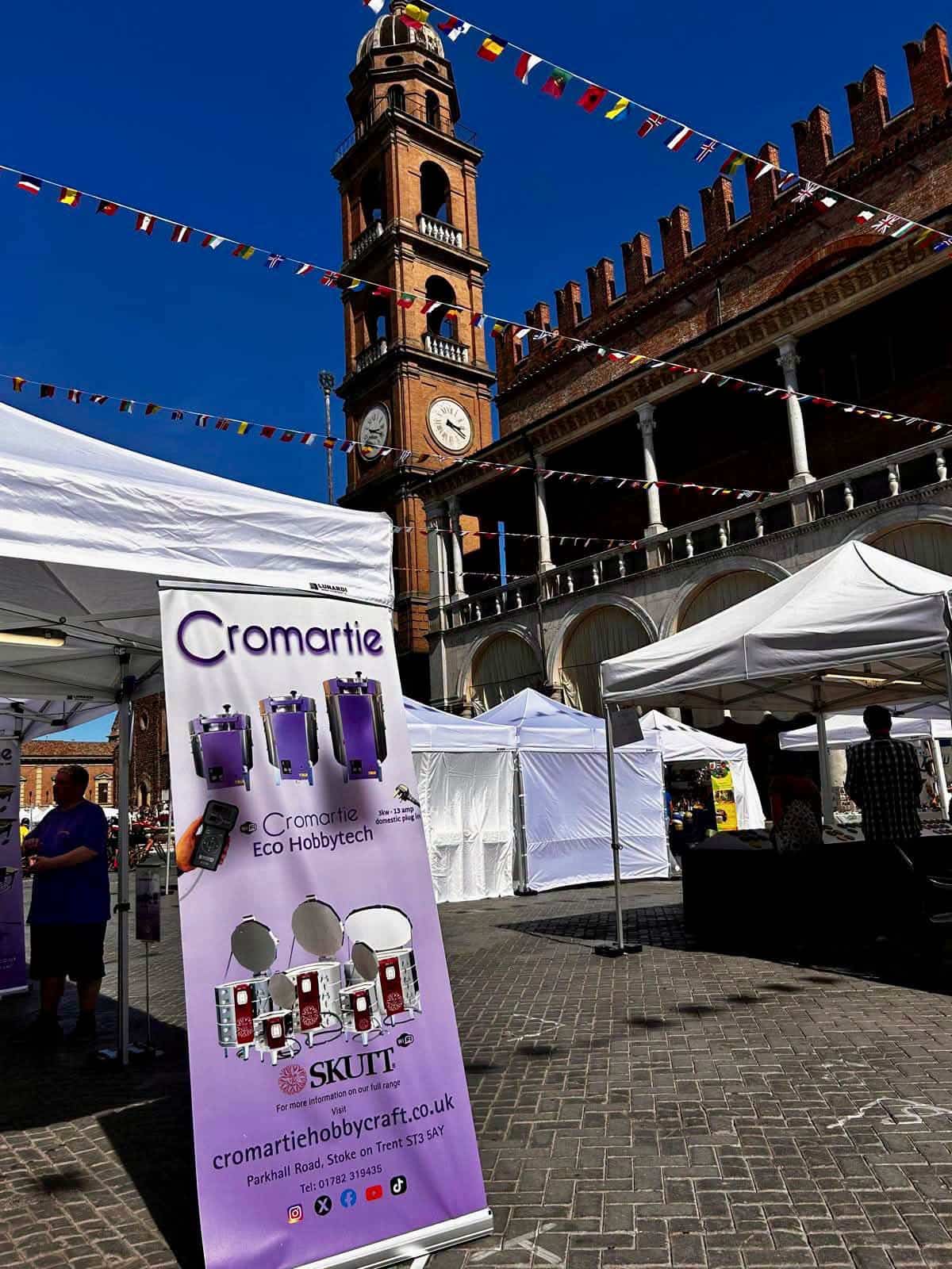 The Cromartie stand at Argillà Italia 2026 with the Faenza clock tower in the background