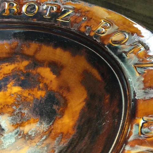BOTZ earthenware glazes showing a selection of fired ceramic glaze colours and decorative effects including metallic, flowing, mottled and crackle finishes