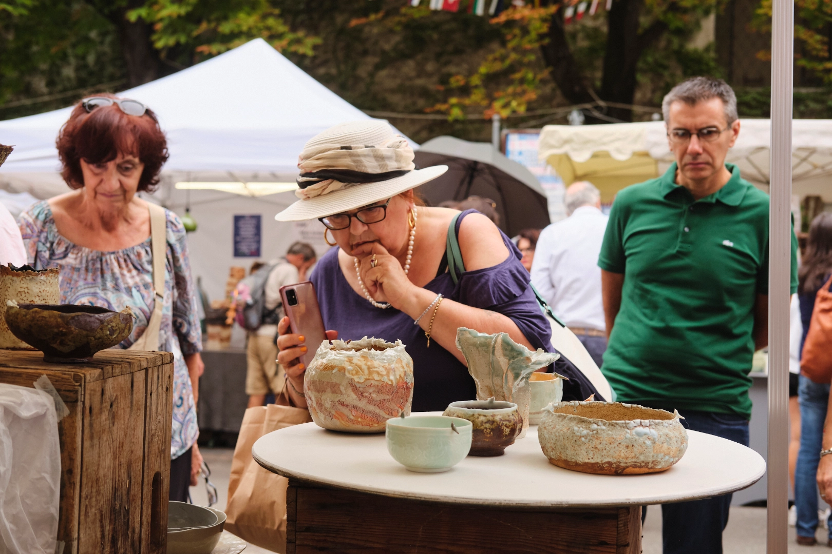 Visitors exploring ceramic stalls at Argillà Italia in Faenza