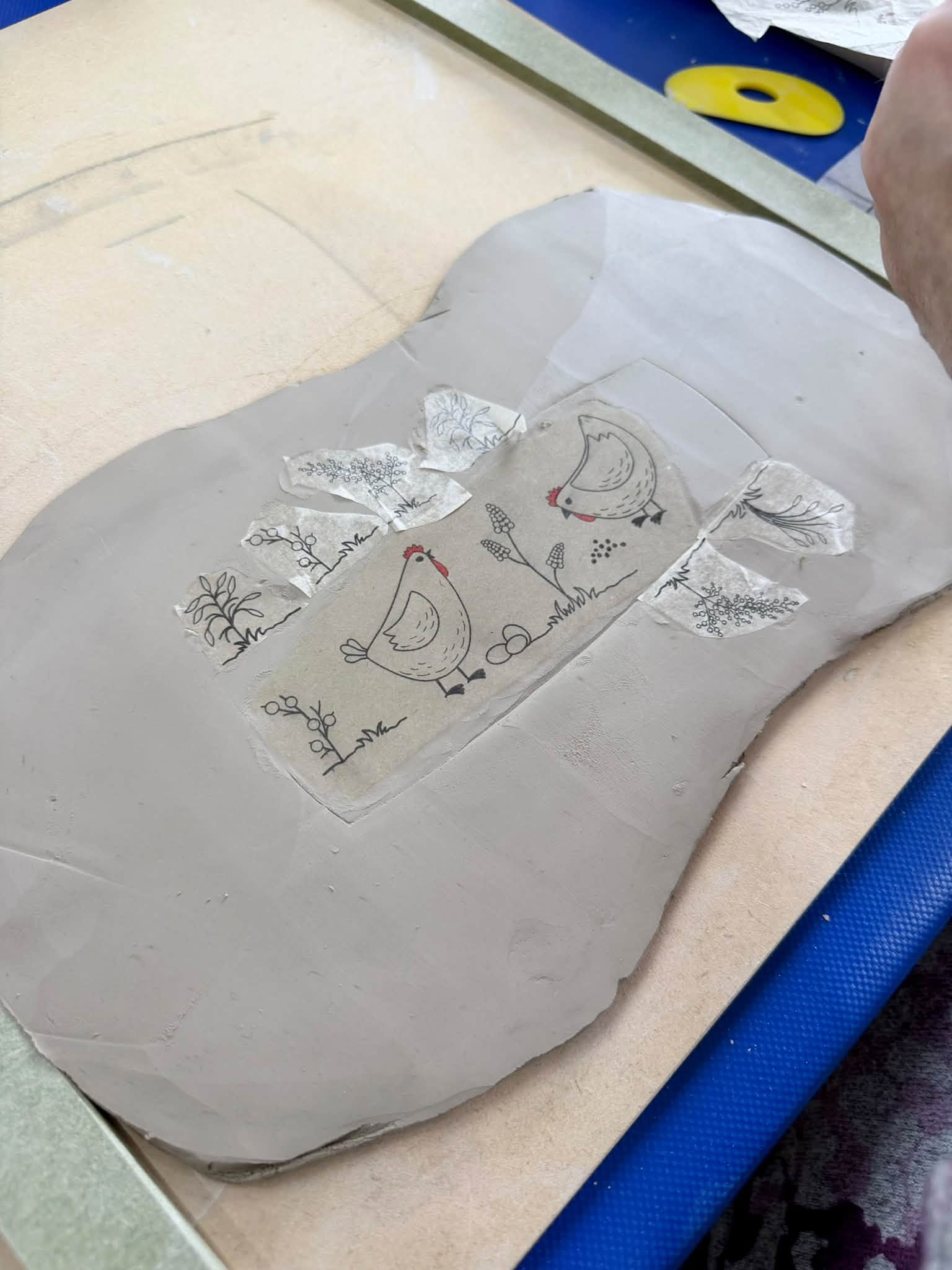 Clay slab decorated with chicken and botanical impressions during the GR Pottery Forms workshop