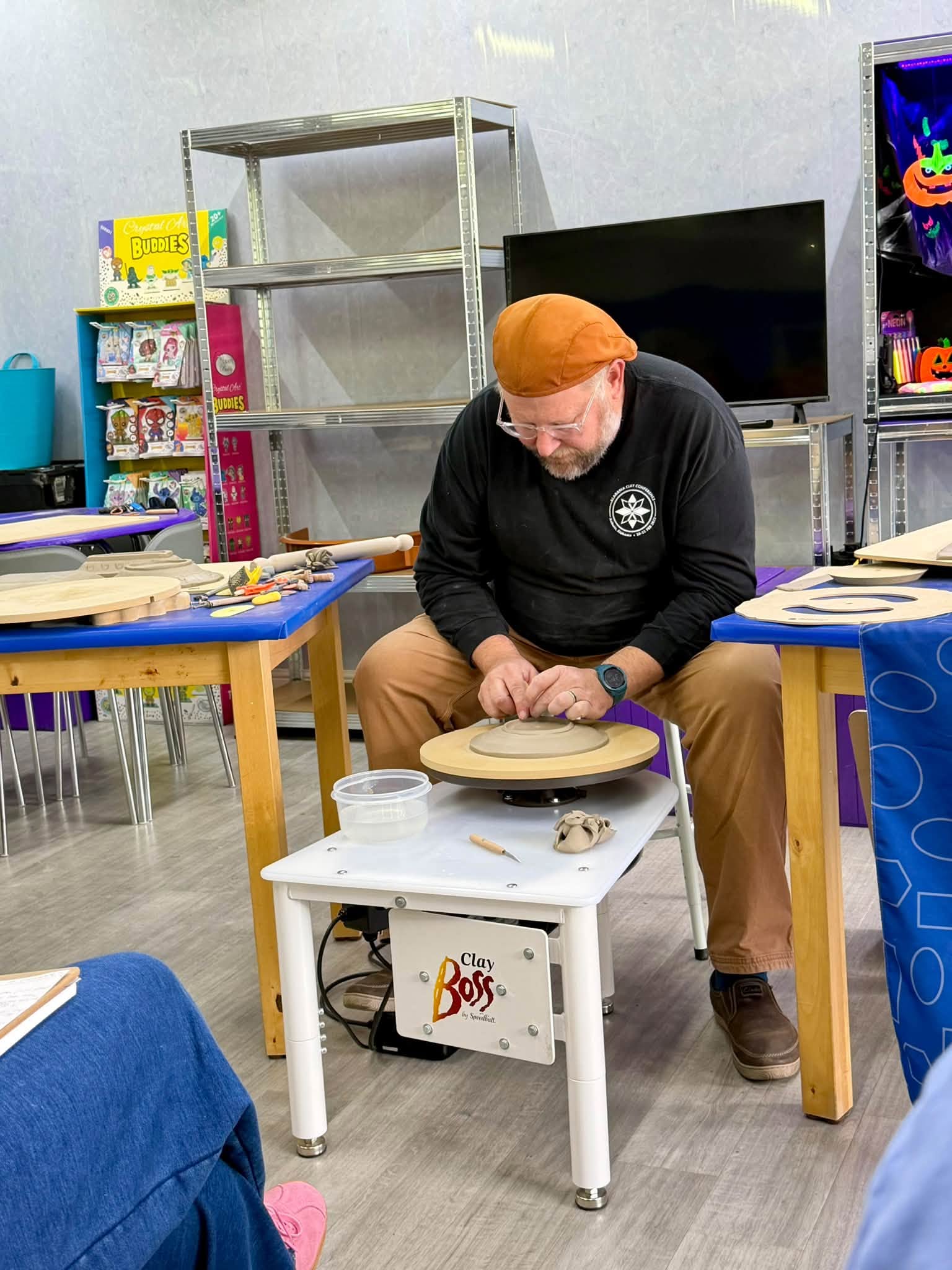Jeff Rottman demonstrating a clay technique on a pottery wheel during the GR Pottery Forms event