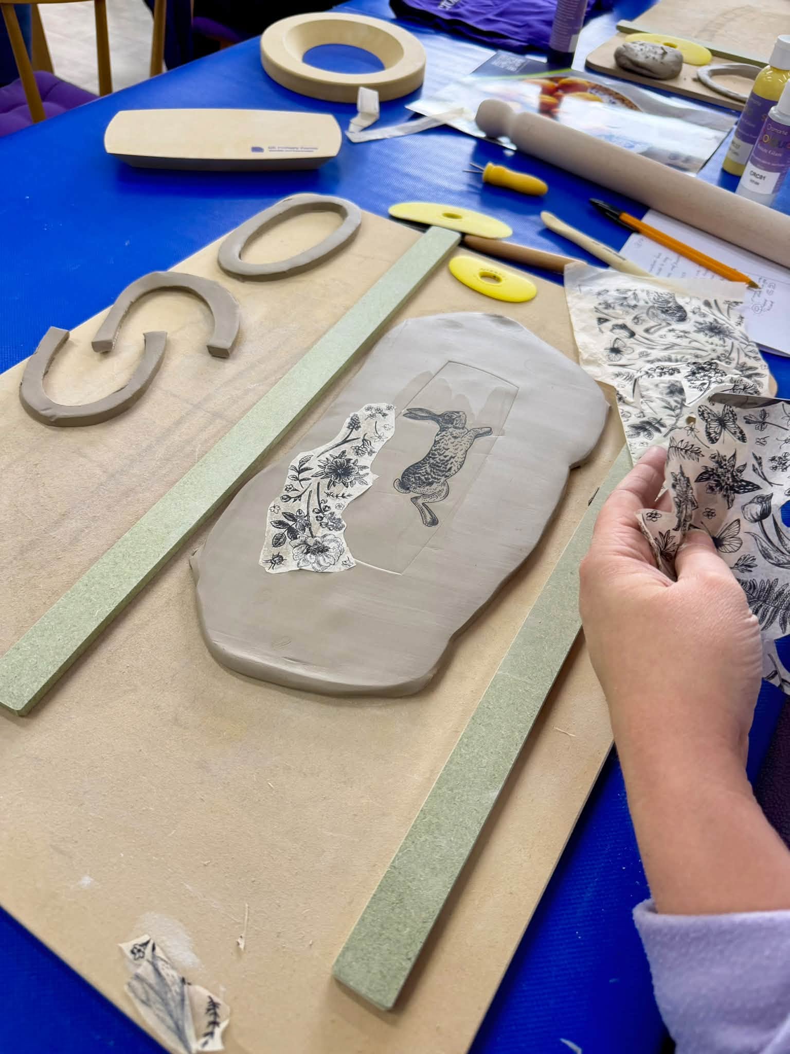 Clay slab with rabbit and floral impression designs during the GR Pottery Forms workshop