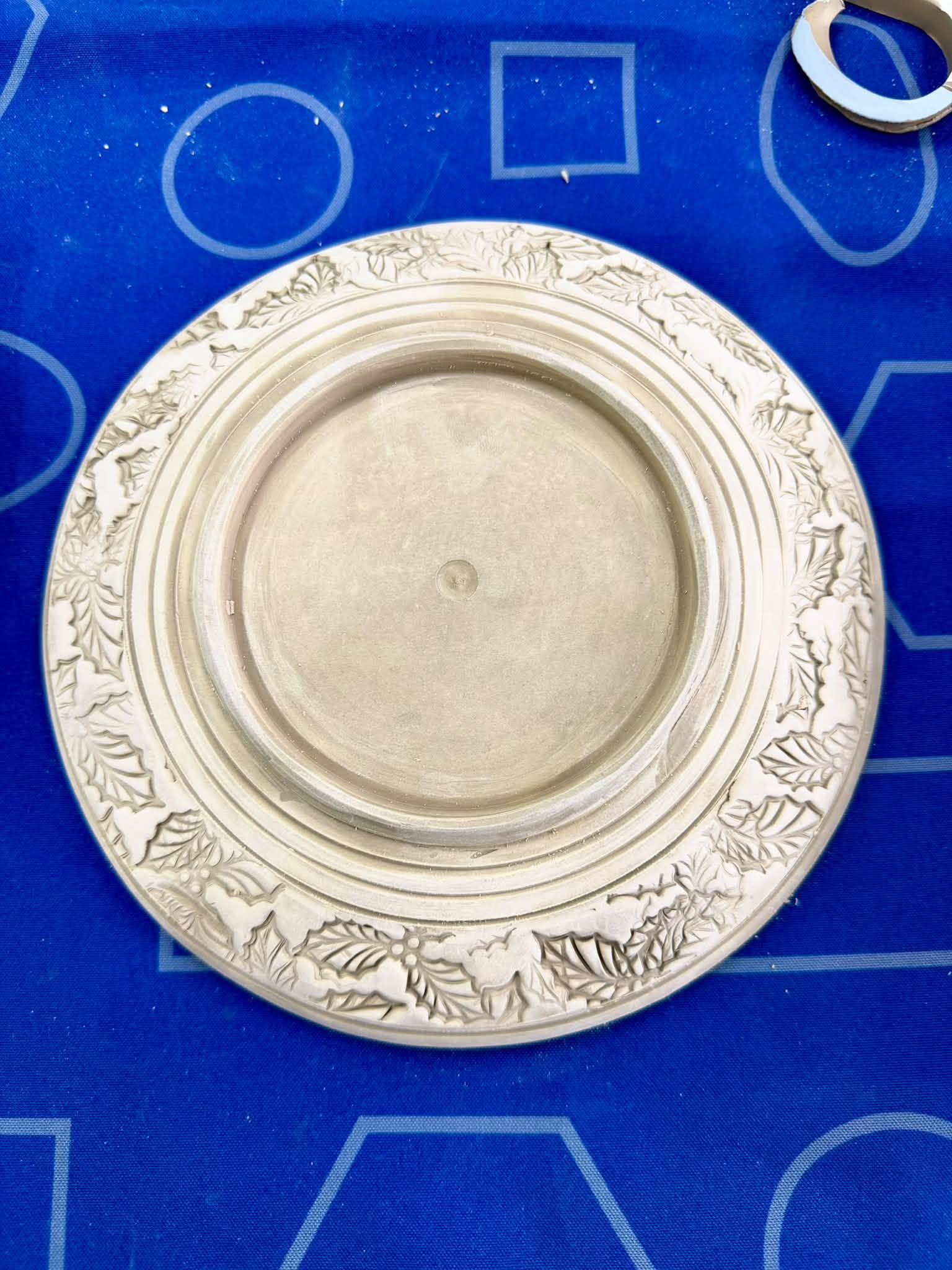 Finished circular clay piece with a detailed impressed border created during the GR Pottery Forms workshop